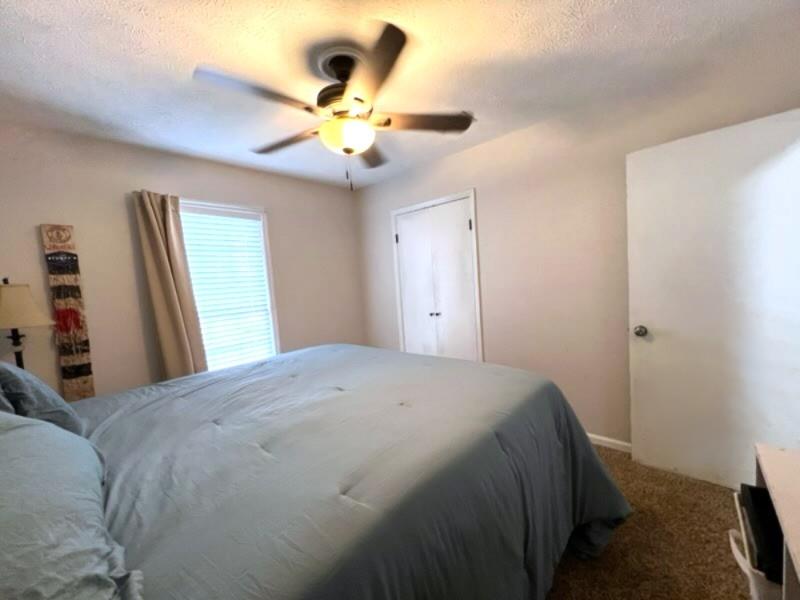 4405 Green Ridge Drive Columbus, GA 31909 - Photo 28 of 31 a bedroom with a bed and a chandelier