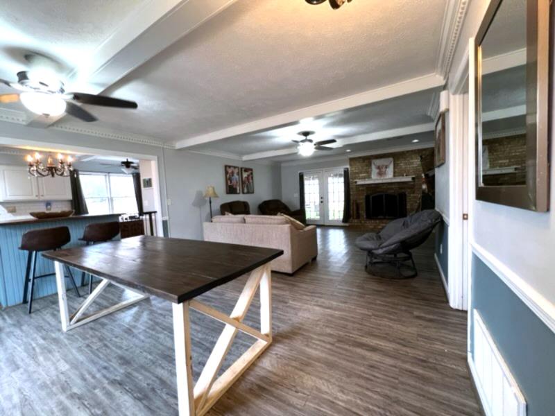 4405 Green Ridge Drive Columbus, GA 31909 - Photo 9 of 31 a living room with furniture a flat screen tv and kitchen view