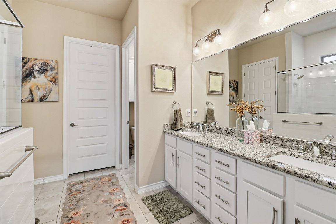 103 Kings Way Horseshoe Bay, TX 78657 - Photo 11 of 20 a spacious bathroom with a granite countertop sink and a mirror