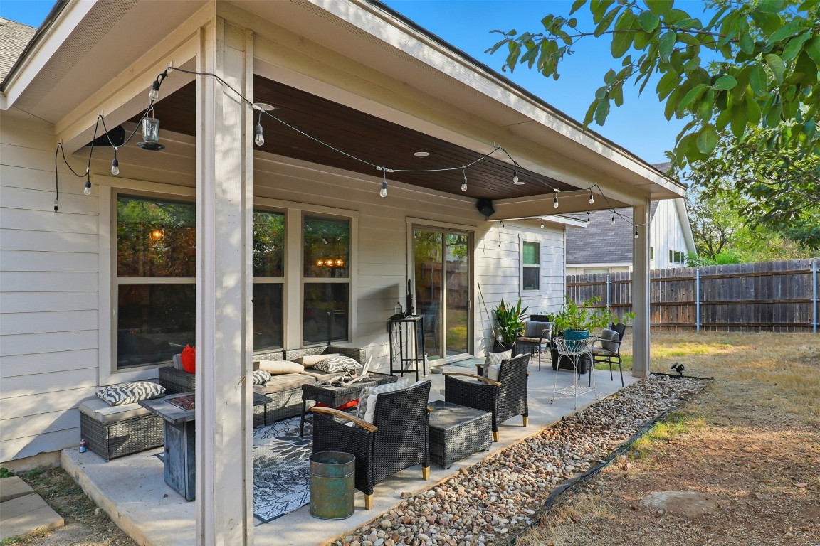 103 Kings Way Horseshoe Bay, TX 78657 - Photo 18 of 20 a view of a patio with table and chairs potted plants and floor to ceiling window