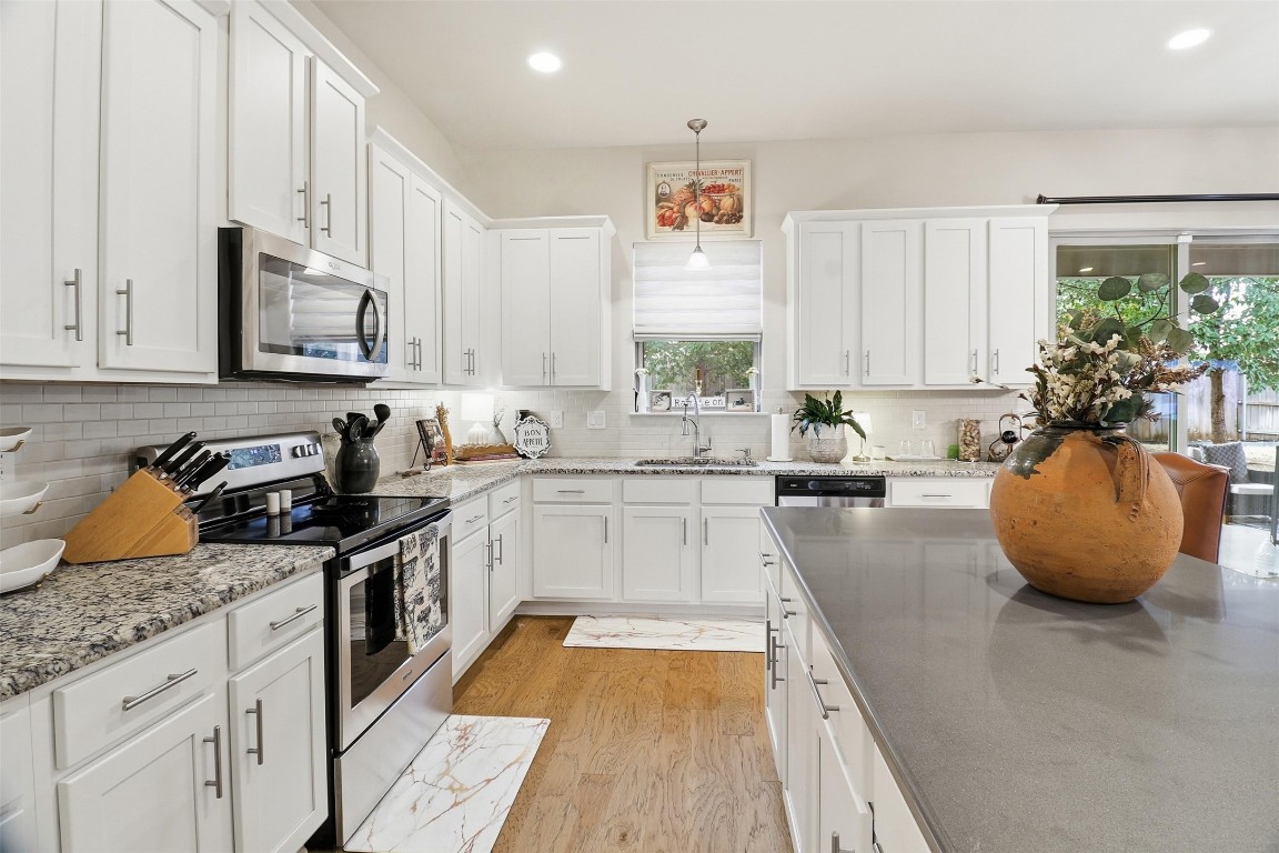 103 Kings Way Horseshoe Bay, TX 78657 - Photo 5 of 20 a kitchen with stainless steel appliances granite countertop a sink a stove and cabinets
