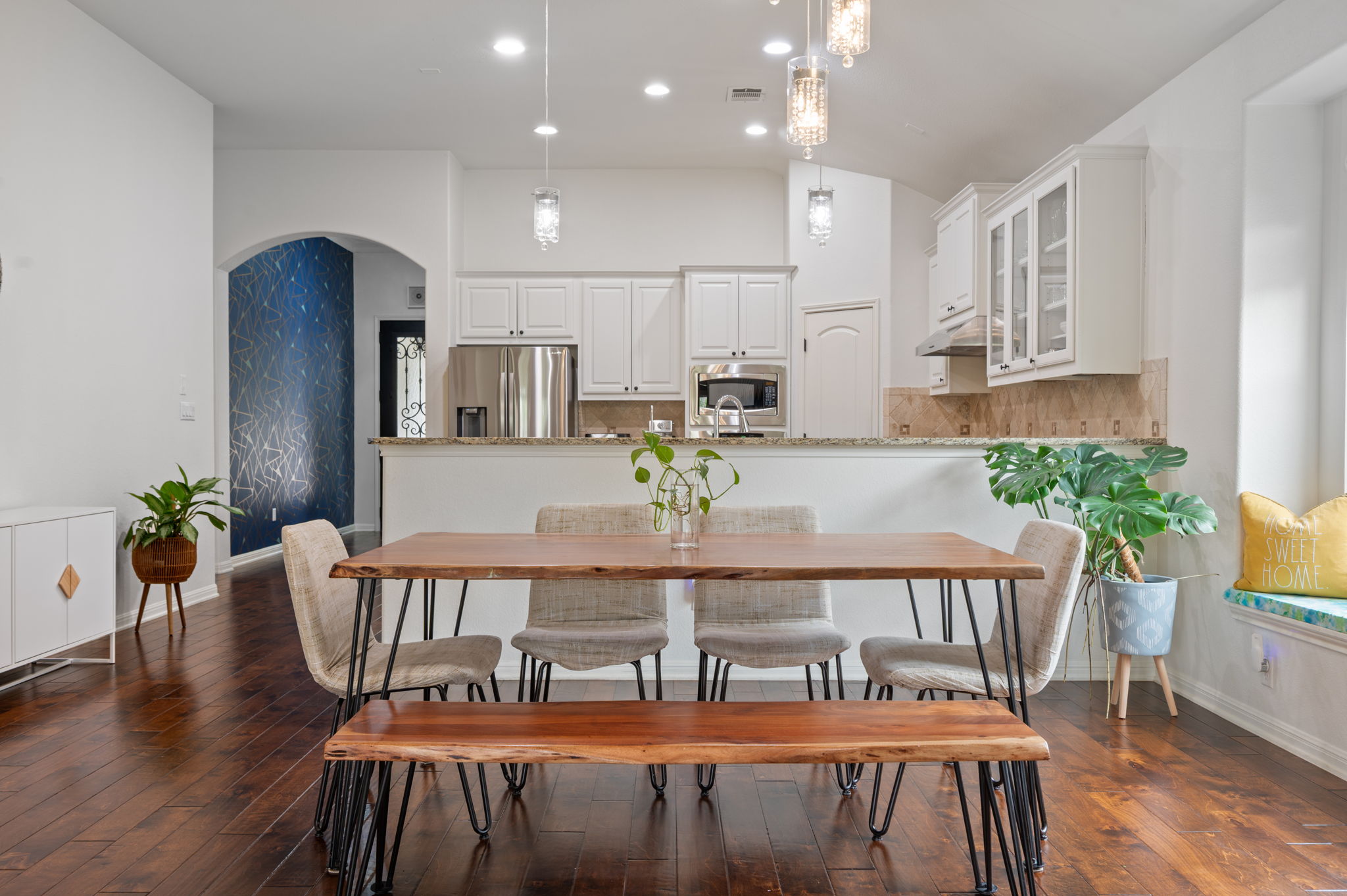 4220 Tambre Bend Austin, TX 78738 - Photo 12 of 28 Dining space with arched walkways, dark wood-style floors, vaulted ceiling, and recessed lighting
