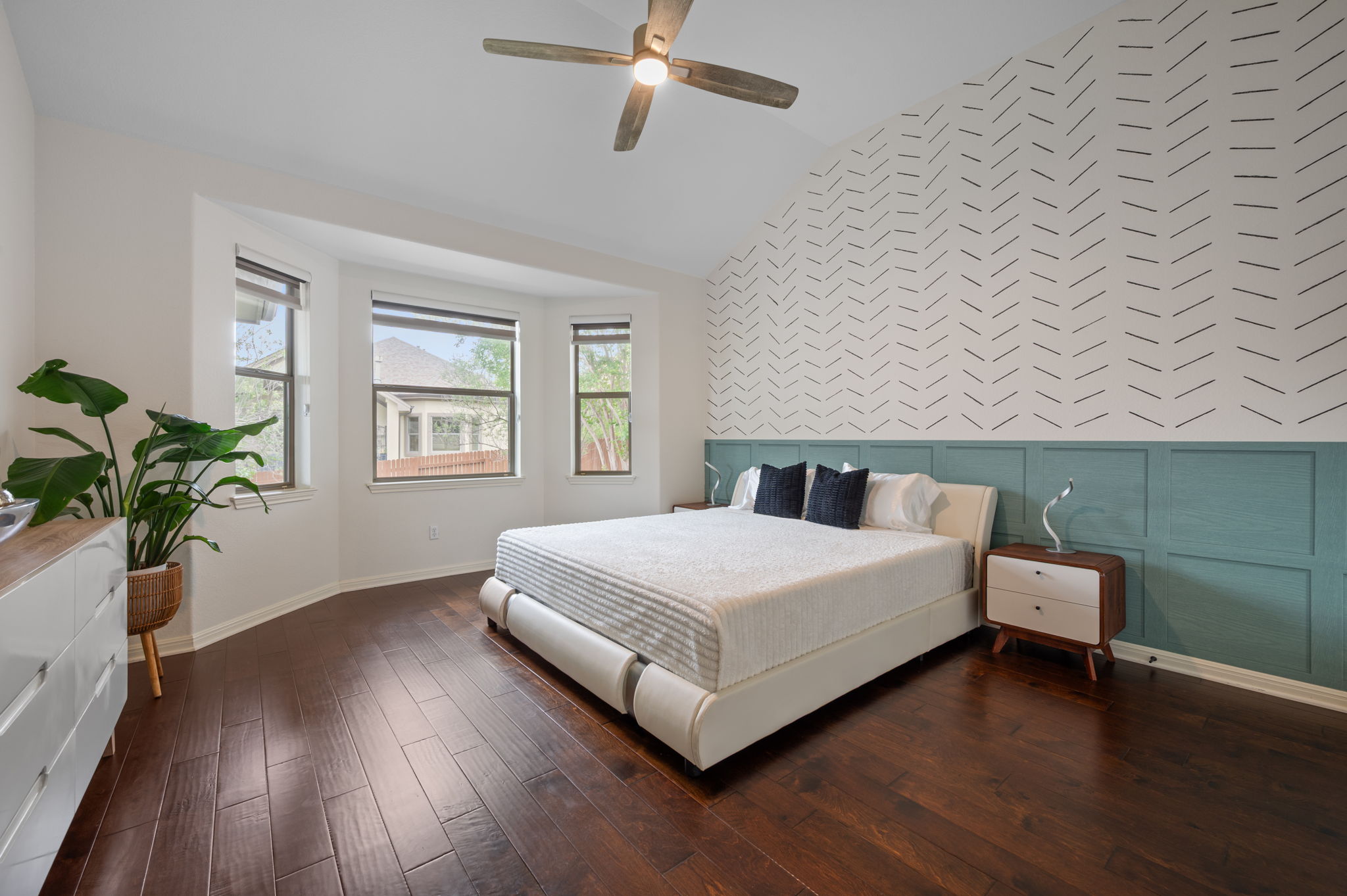 4220 Tambre Bend Austin, TX 78738 - Photo 16 of 28 Bedroom with dark wood-type flooring, vaulted ceiling, ceiling fan, an accent wall, and wallpapered walls