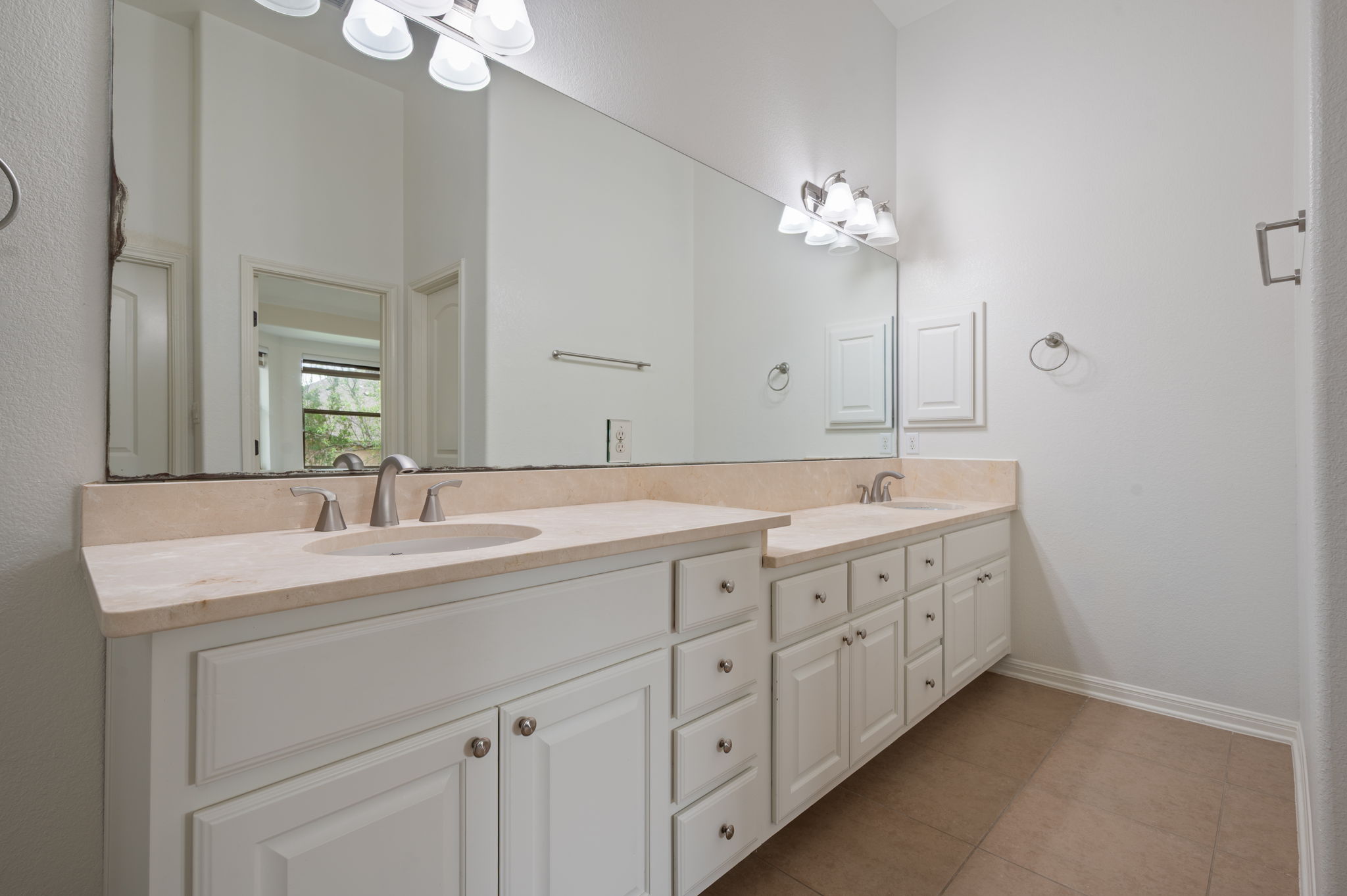 4220 Tambre Bend Austin, TX 78738 - Photo 18 of 28 Full bath with double vanity, a chandelier, and light tile patterned floors