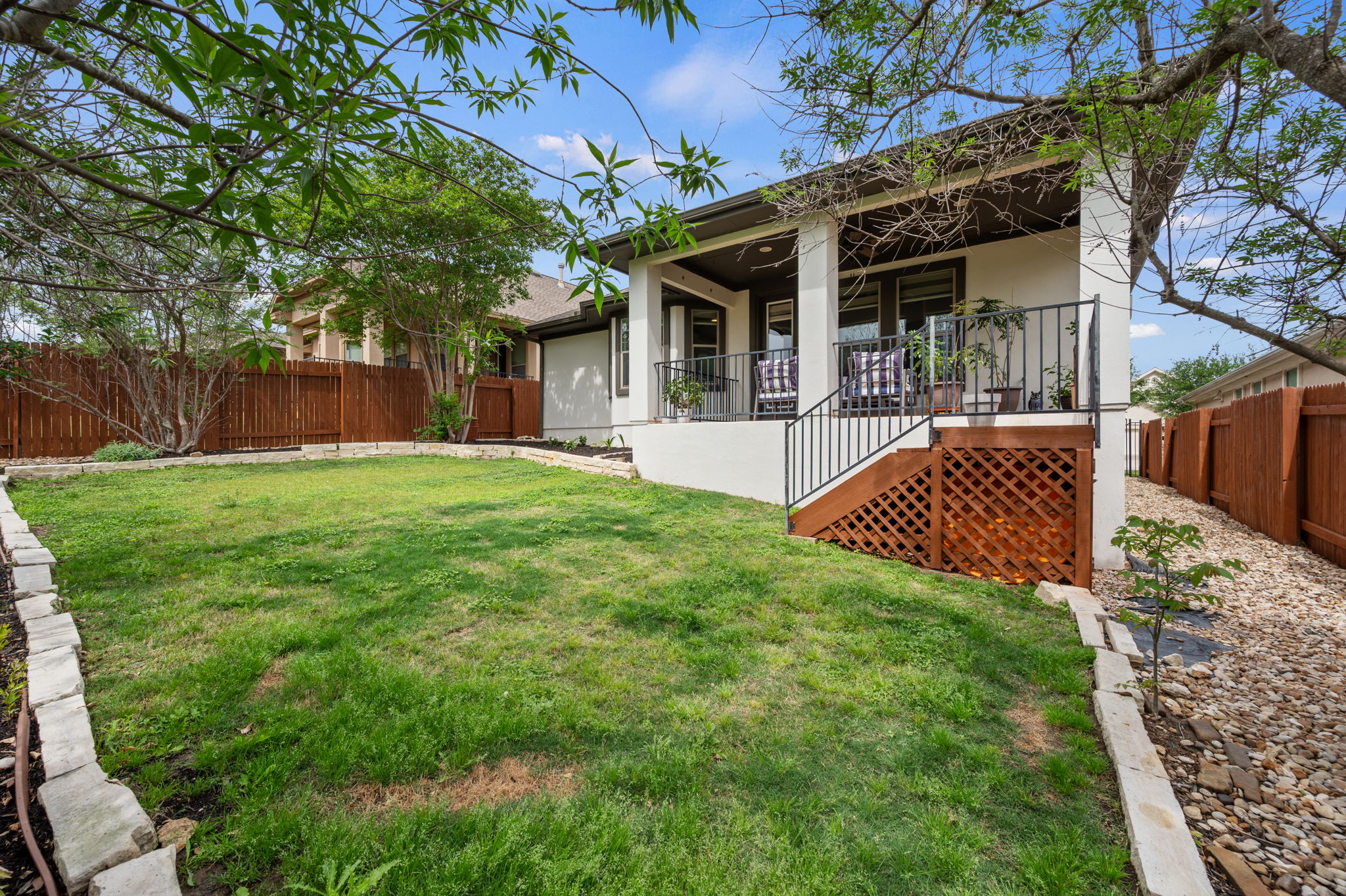 4220 Tambre Bend Austin, TX 78738 - Photo 27 of 28 Rear view of property featuring a fenced backyard and stucco siding