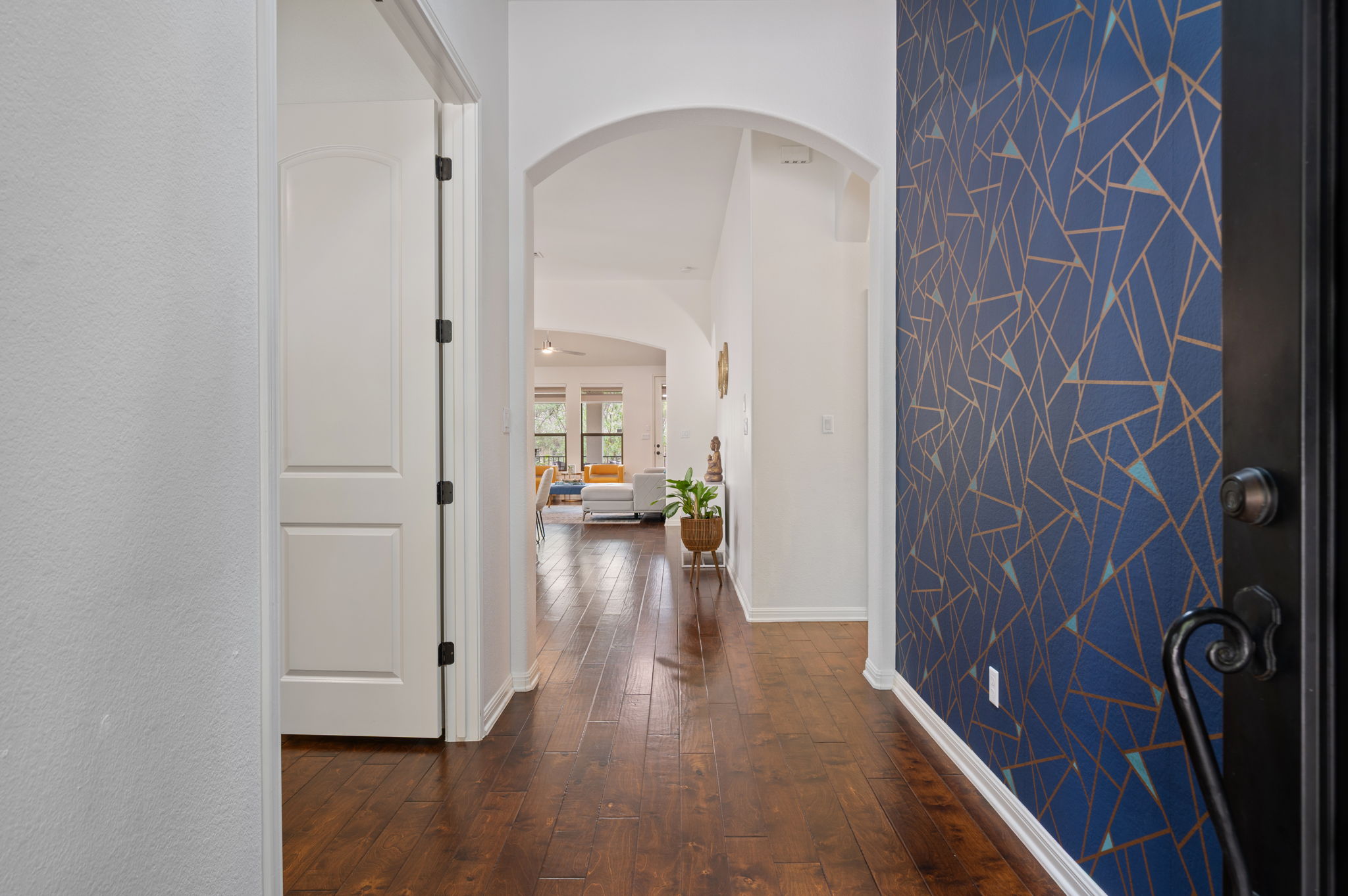 4220 Tambre Bend Austin, TX 78738 - Photo 3 of 28 Corridor featuring arched walkways and dark wood-style floors