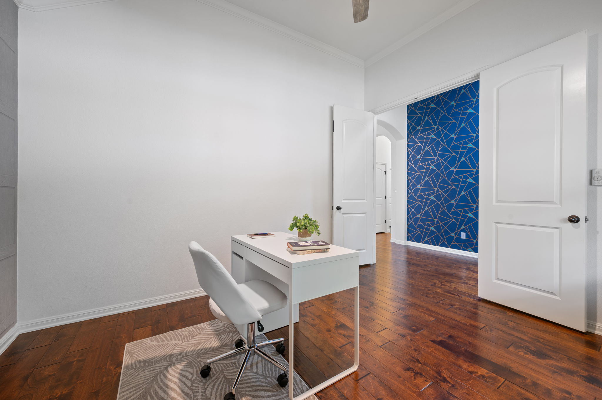 4220 Tambre Bend Austin, TX 78738 - Photo 6 of 28 Home office featuring arched walkways, ornamental molding, dark wood-style flooring, and a ceiling fan