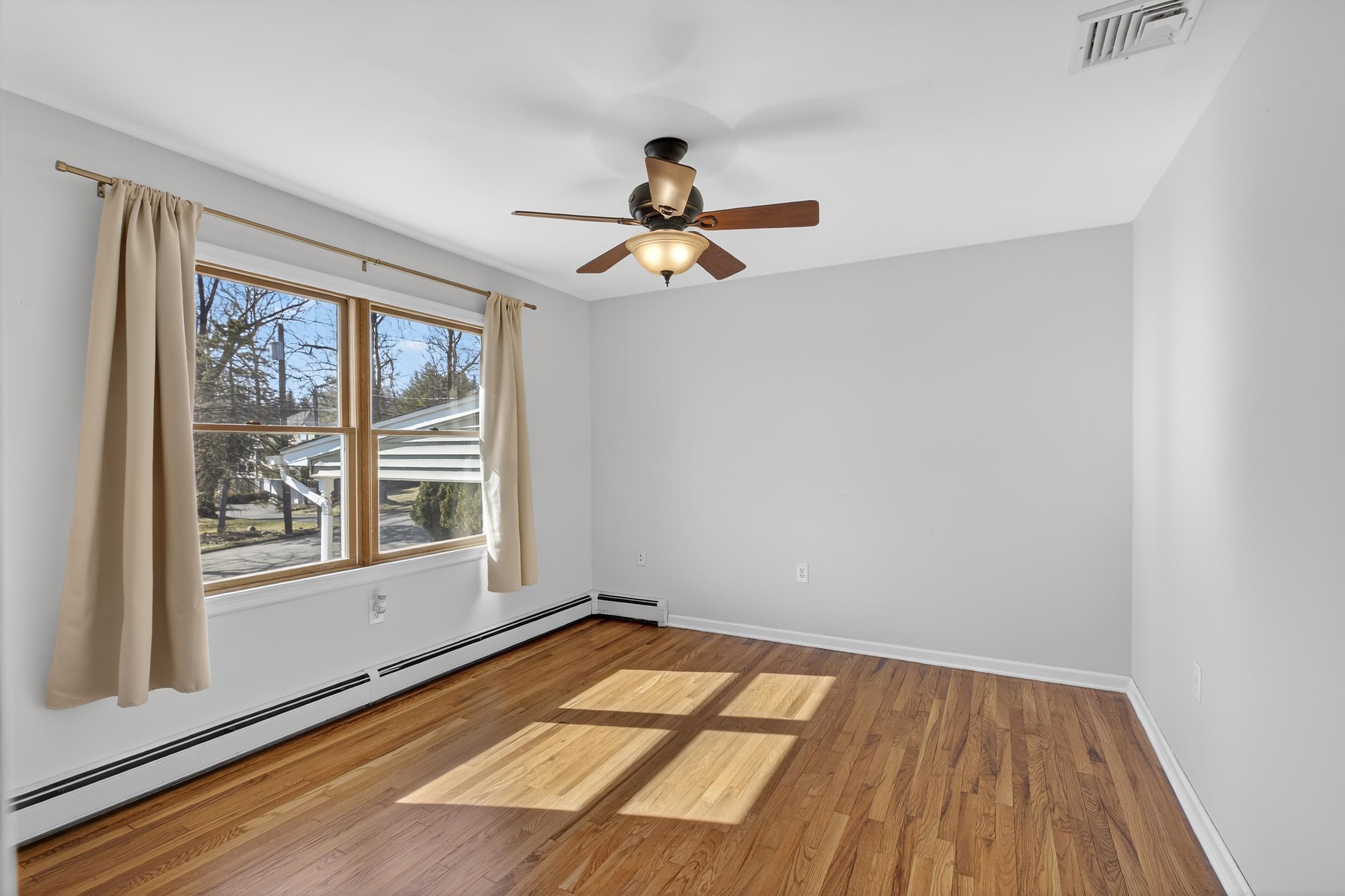 33 Georgia Drive Wayne, NJ 07470 - Photo 11 of 36 wooden floor in an empty room with a window