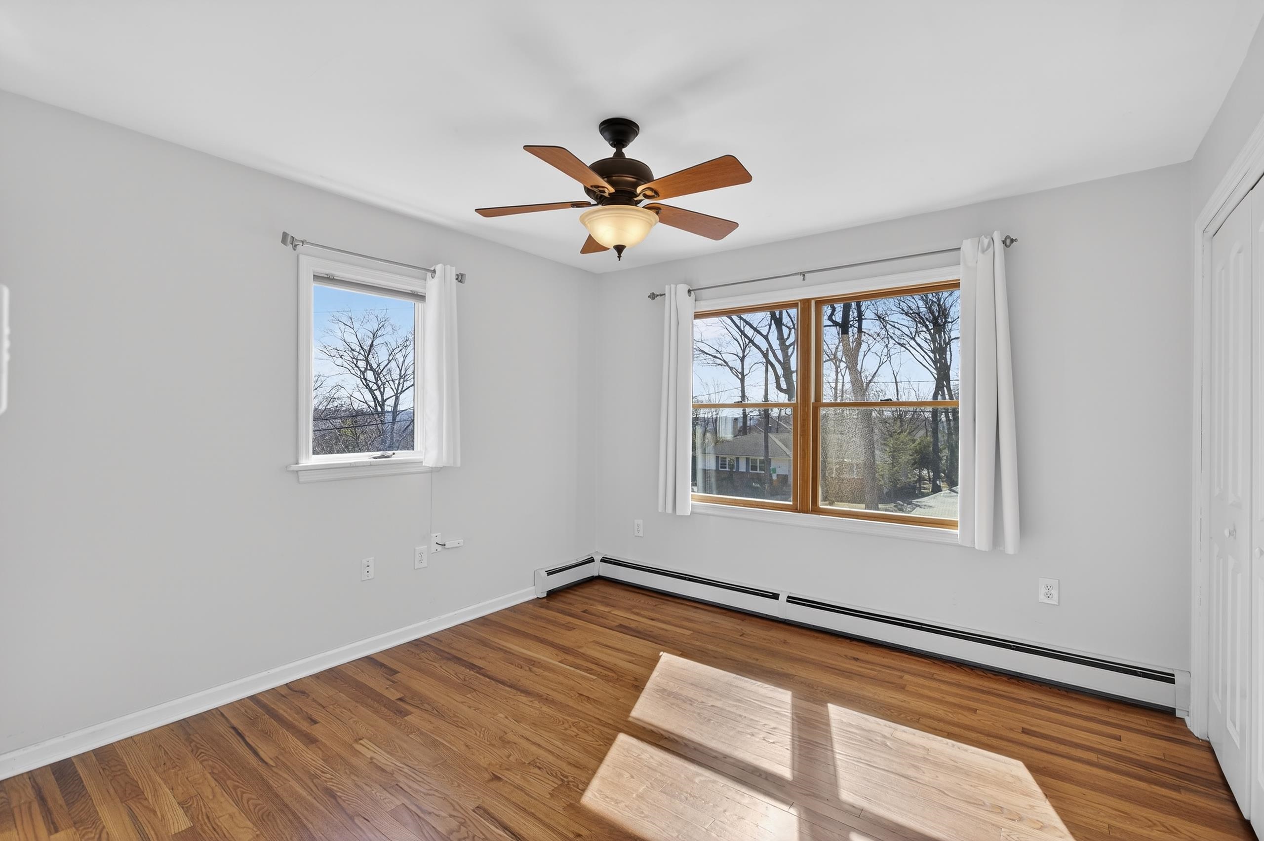 33 Georgia Drive Wayne, NJ 07470 - Photo 12 of 36 a view of empty room with wooden floor and fan