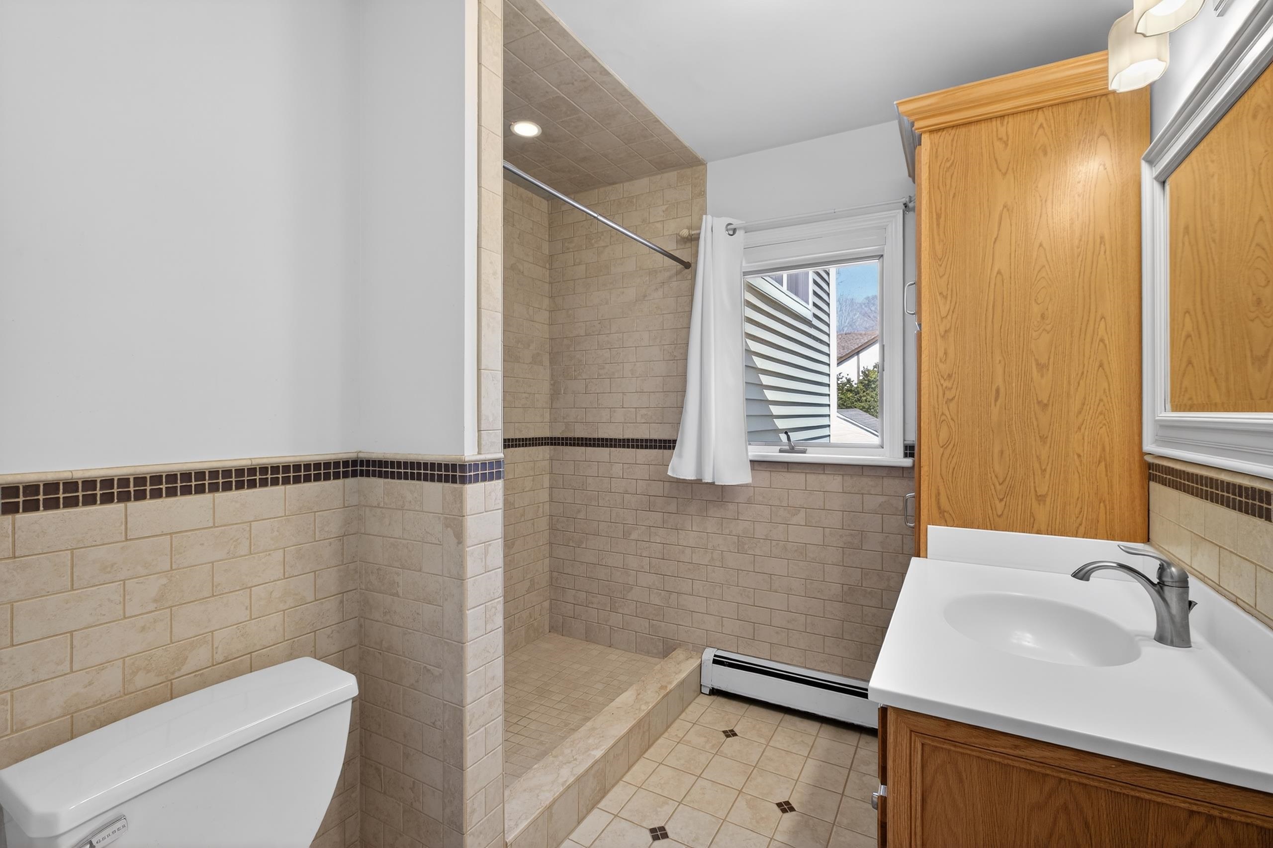 33 Georgia Drive Wayne, NJ 07470 - Photo 15 of 36 a bathroom with a sink toilet and shower