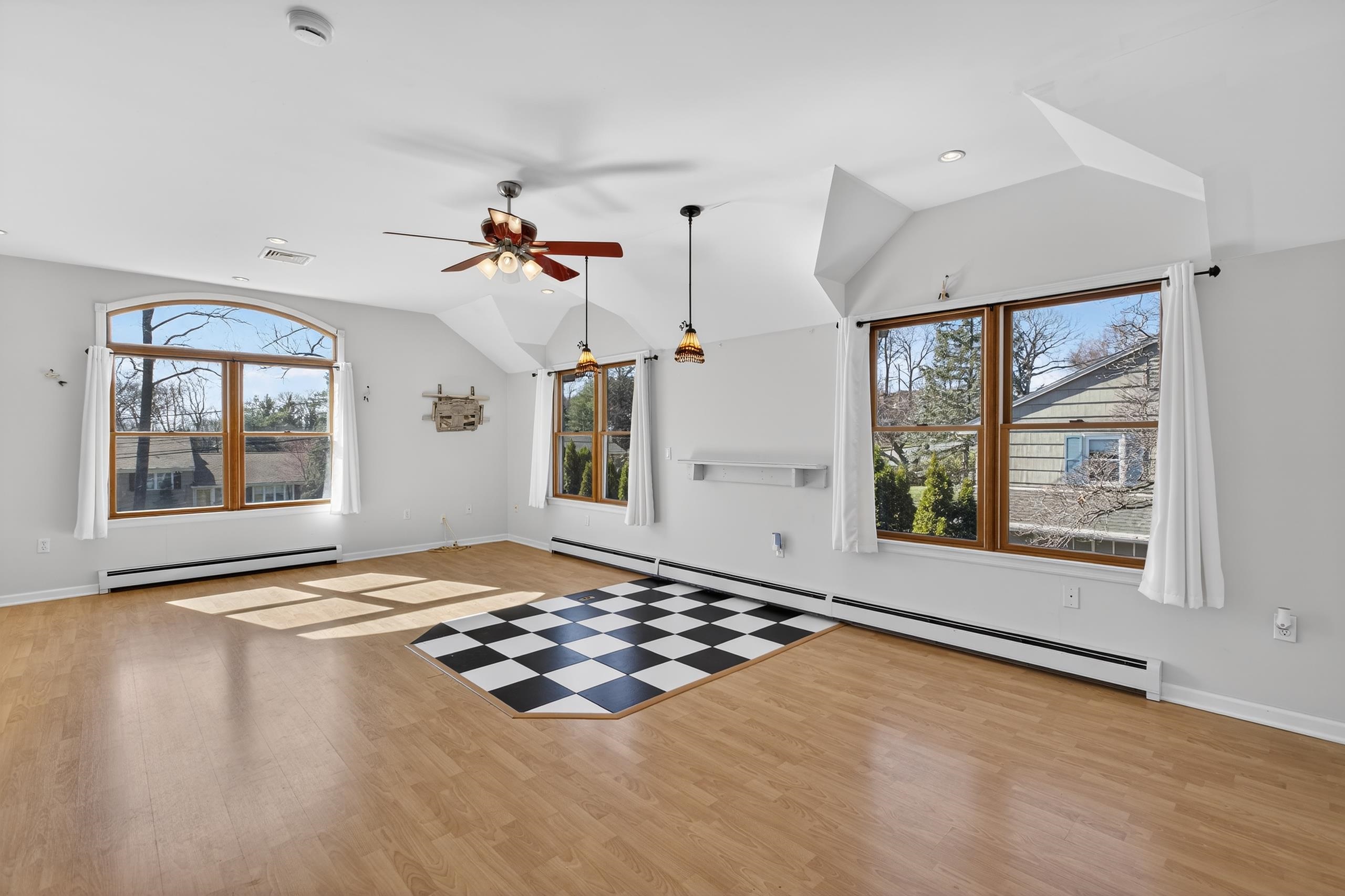 33 Georgia Drive Wayne, NJ 07470 - Photo 19 of 36 a view of an empty room with a window and wooden floor