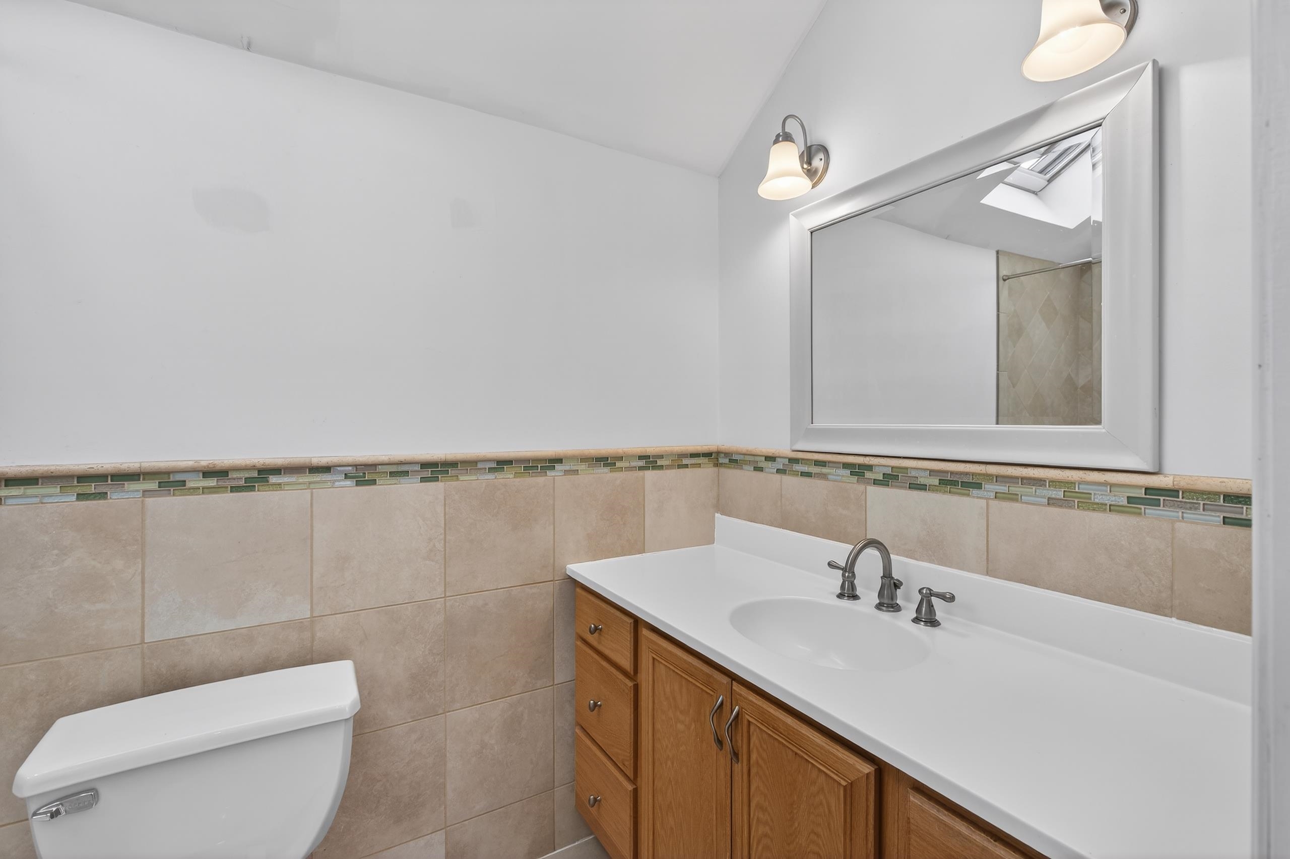 33 Georgia Drive Wayne, NJ 07470 - Photo 22 of 36 a bathroom with a sink a toilet and mirror