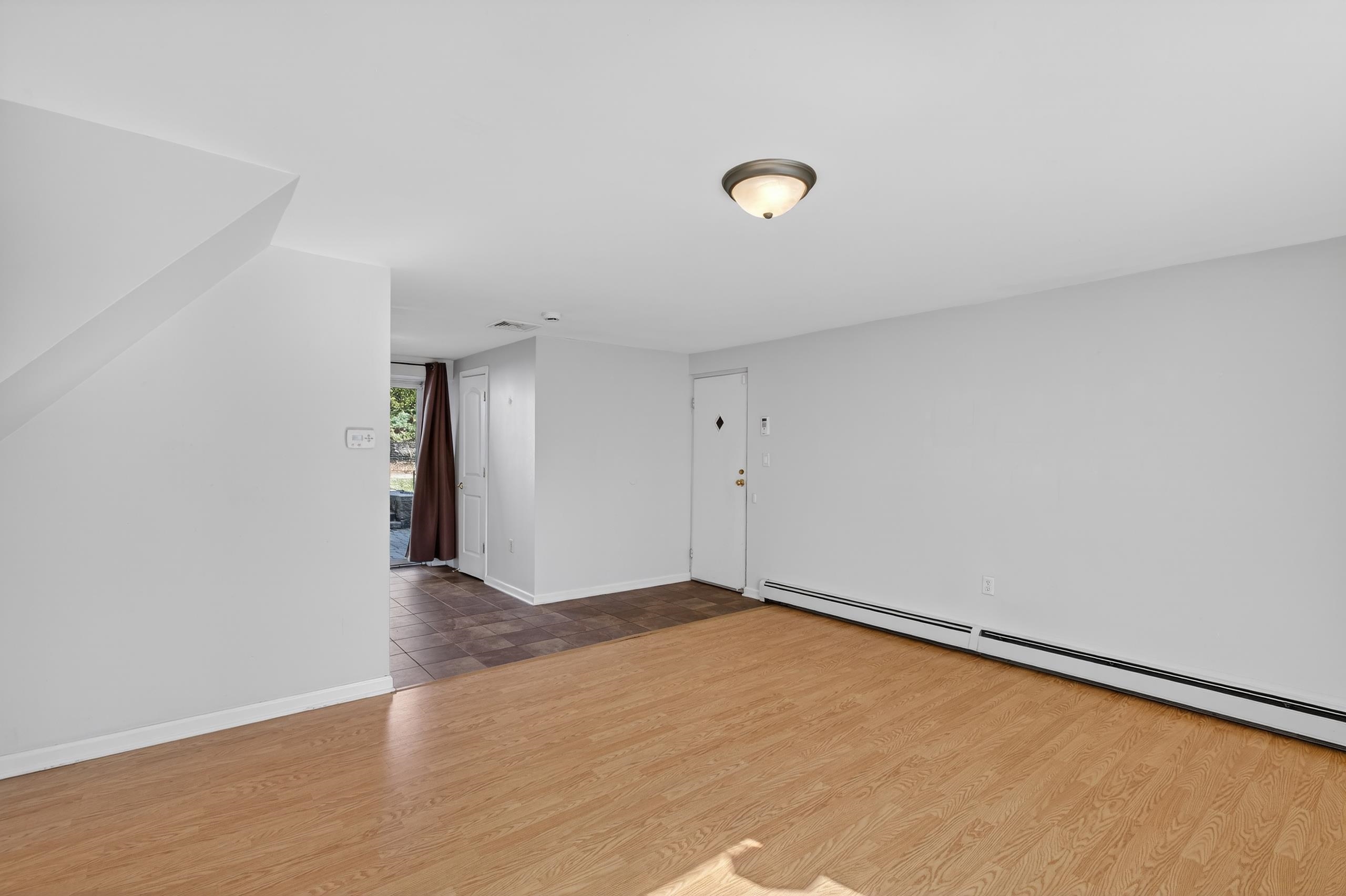 33 Georgia Drive Wayne, NJ 07470 - Photo 24 of 36 an empty room with wooden floor and windows