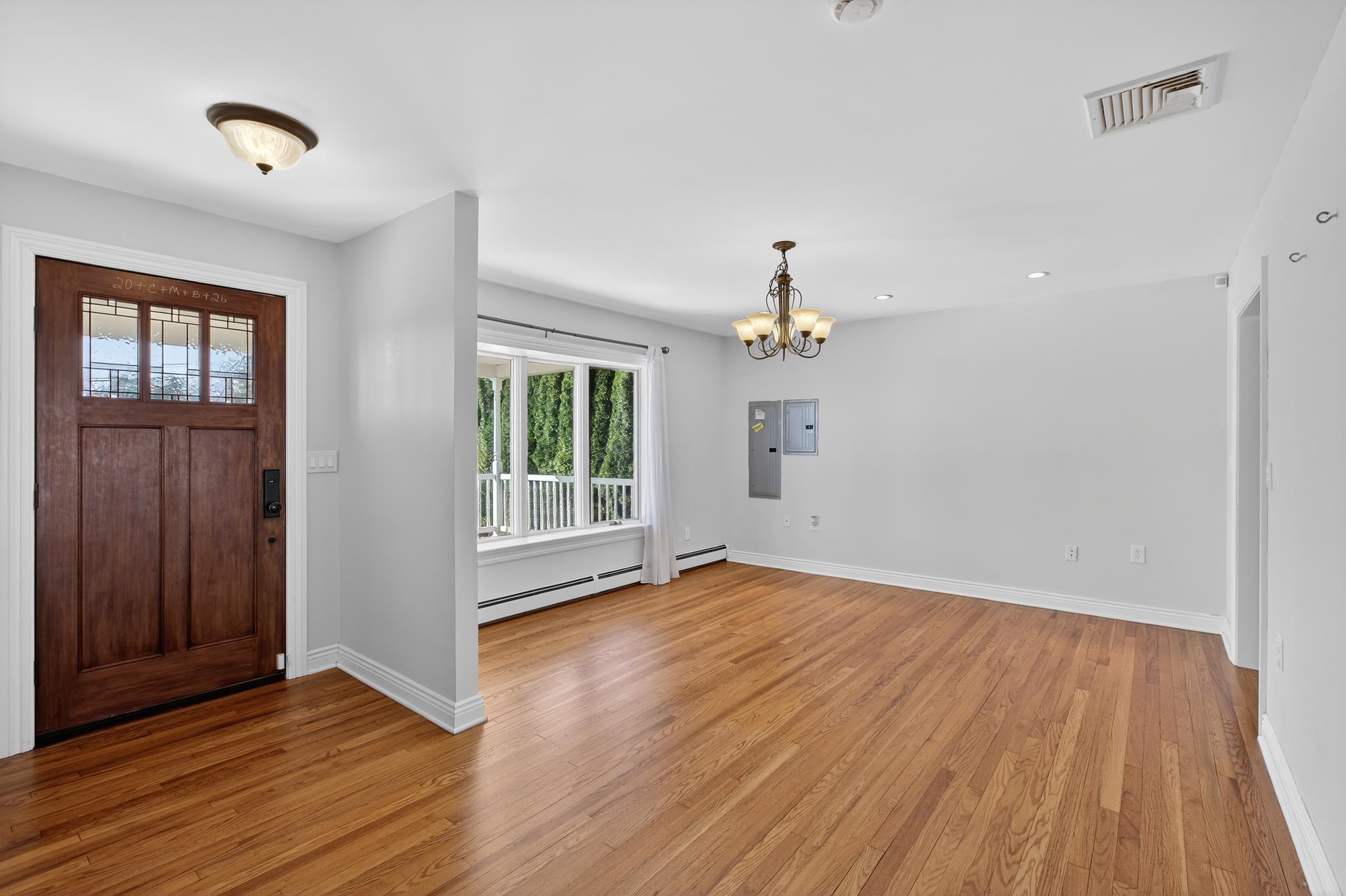 33 Georgia Drive Wayne, NJ 07470 - Photo 3 of 36 a view of empty room with wooden floor and fan