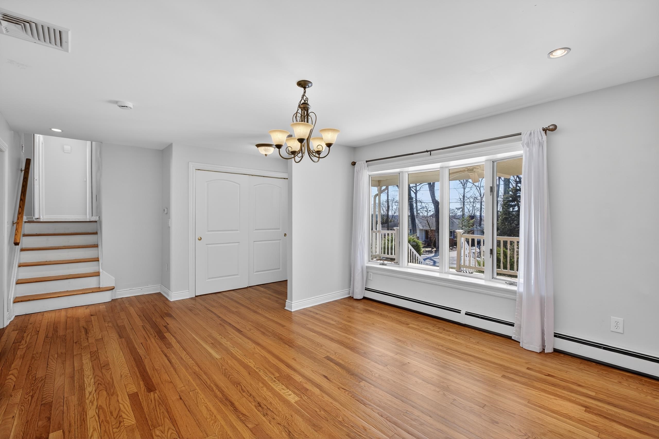 33 Georgia Drive Wayne, NJ 07470 - Photo 4 of 36 a view of an empty room with wooden floor and a window