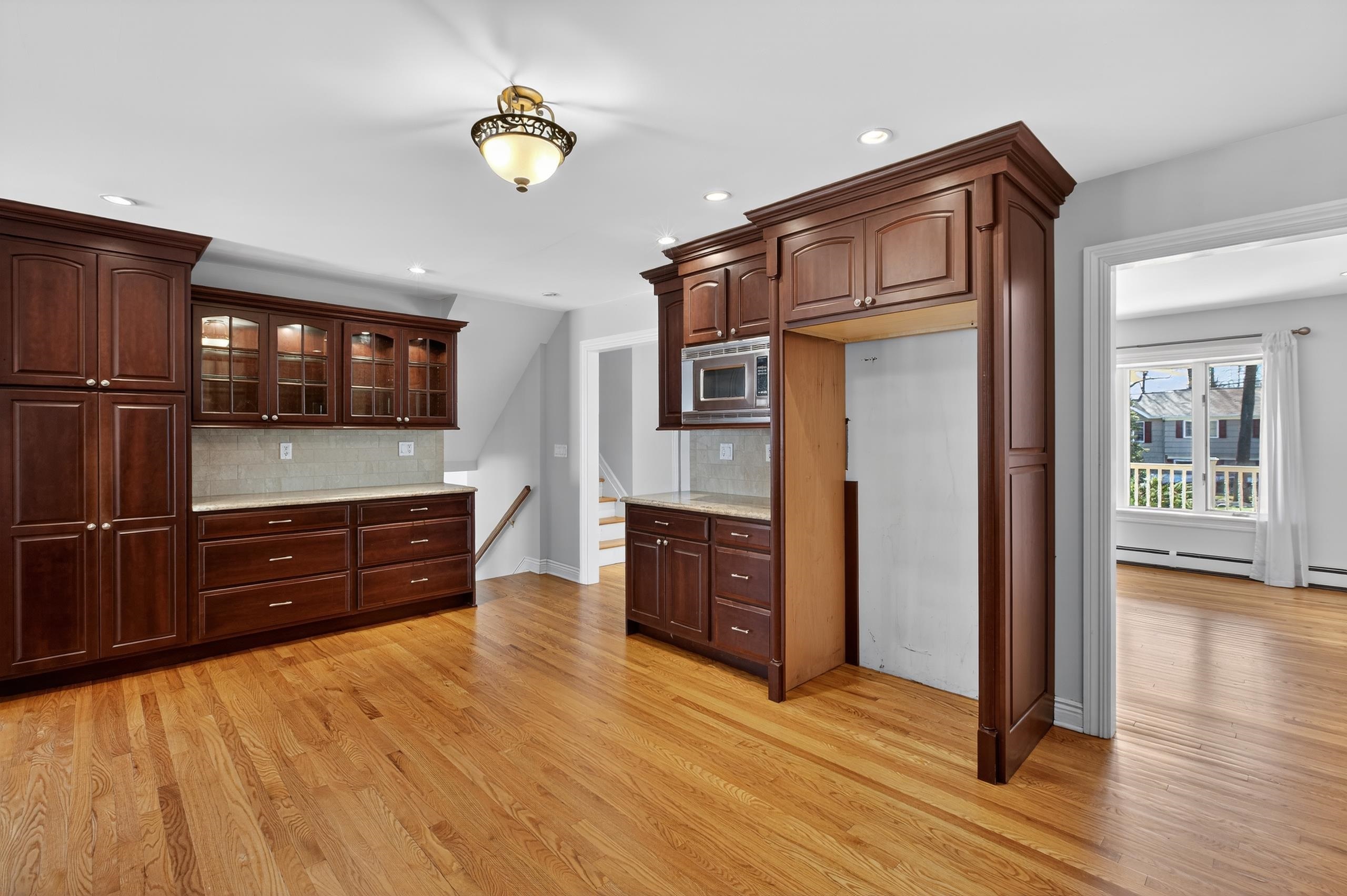 33 Georgia Drive Wayne, NJ 07470 - Photo 6 of 36 a kitchen with stainless steel appliances granite countertop a refrigerator and a wooden floors