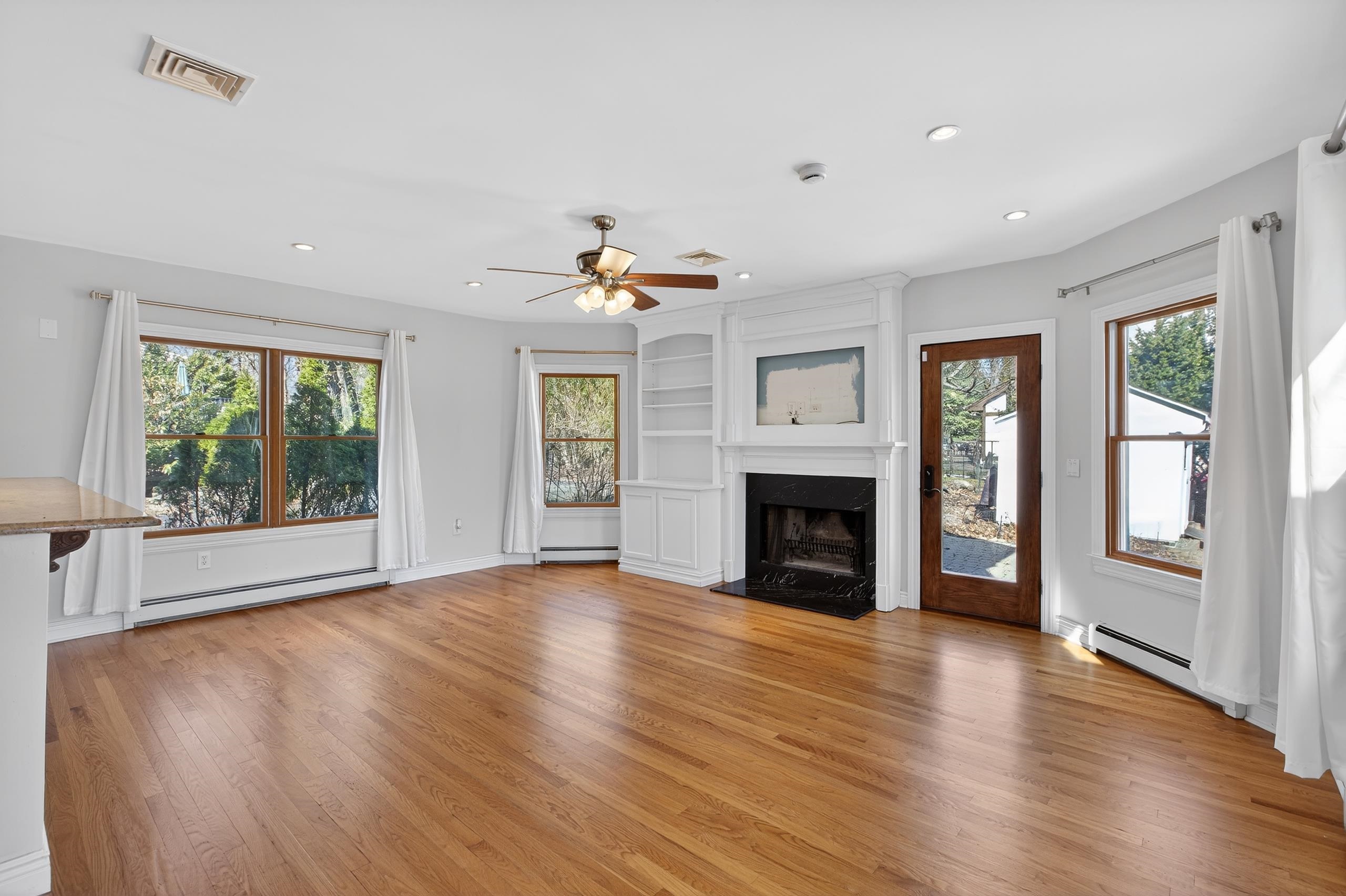 33 Georgia Drive Wayne, NJ 07470 - Photo 8 of 36 a view of an empty room with a window and fireplace