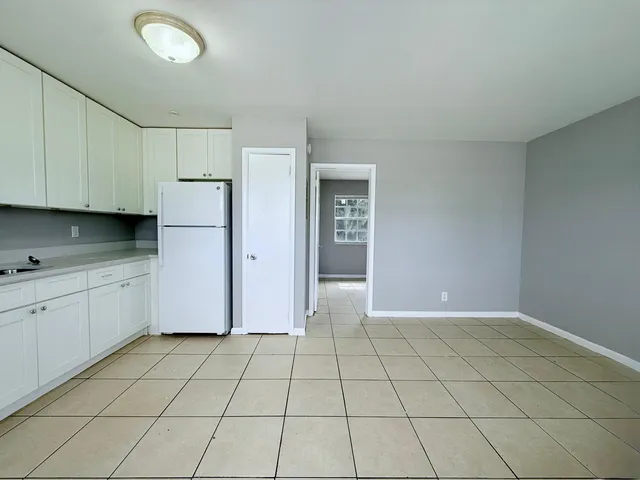 a view of a kitchen with white cabinets