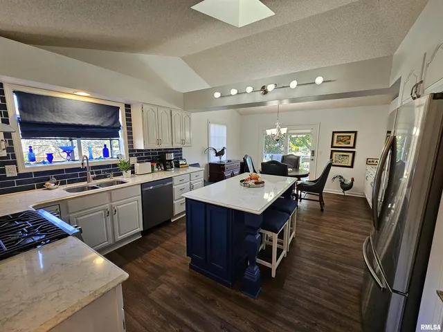 a kitchen with a sink appliances and cabinets