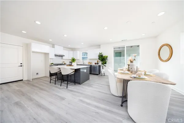 a kitchen with kitchen island granite countertop a white cabinets and chairs