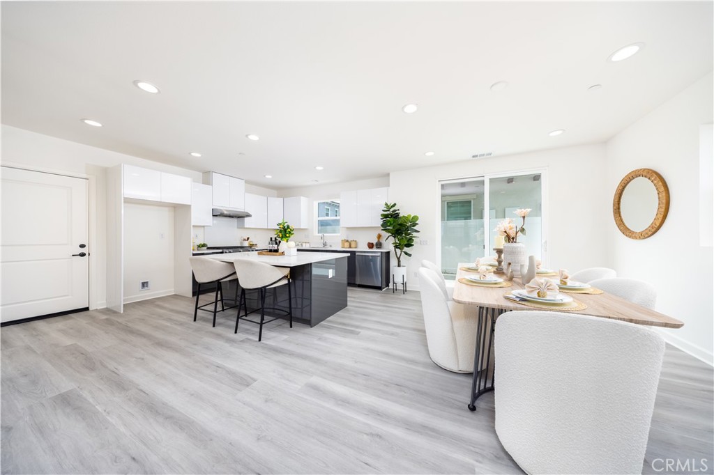 1371 Point Loma Place Walnut, CA 91789 - Photo 18 of 33 a living room with stainless steel appliances kitchen island a table and chairs in it