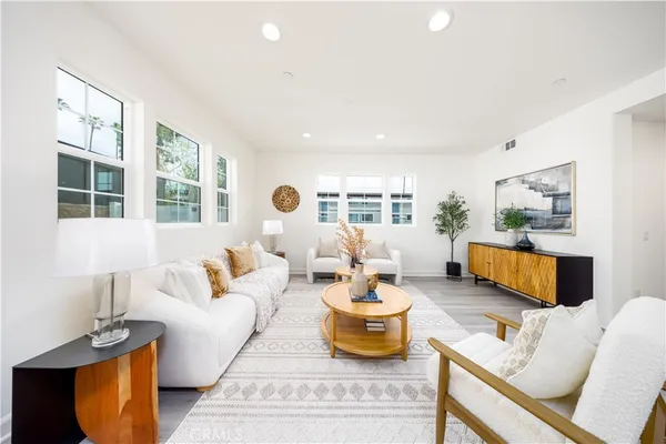 a living room with furniture a potted plant and a table
