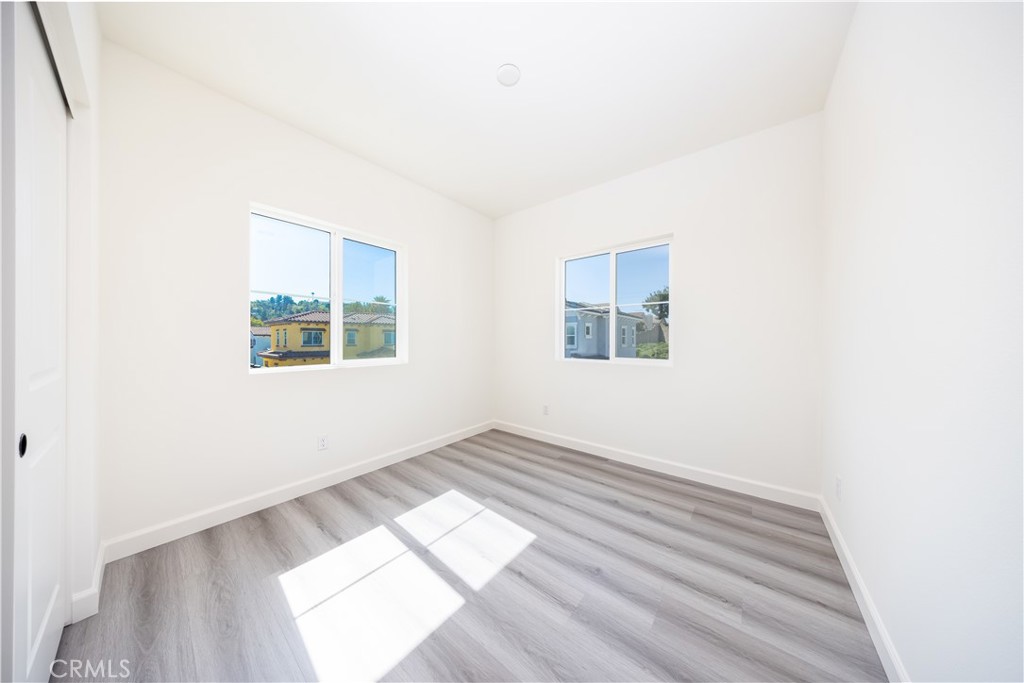 1371 Point Loma Place Walnut, CA 91789 - Photo 25 of 33 an empty room with wooden floor and windows