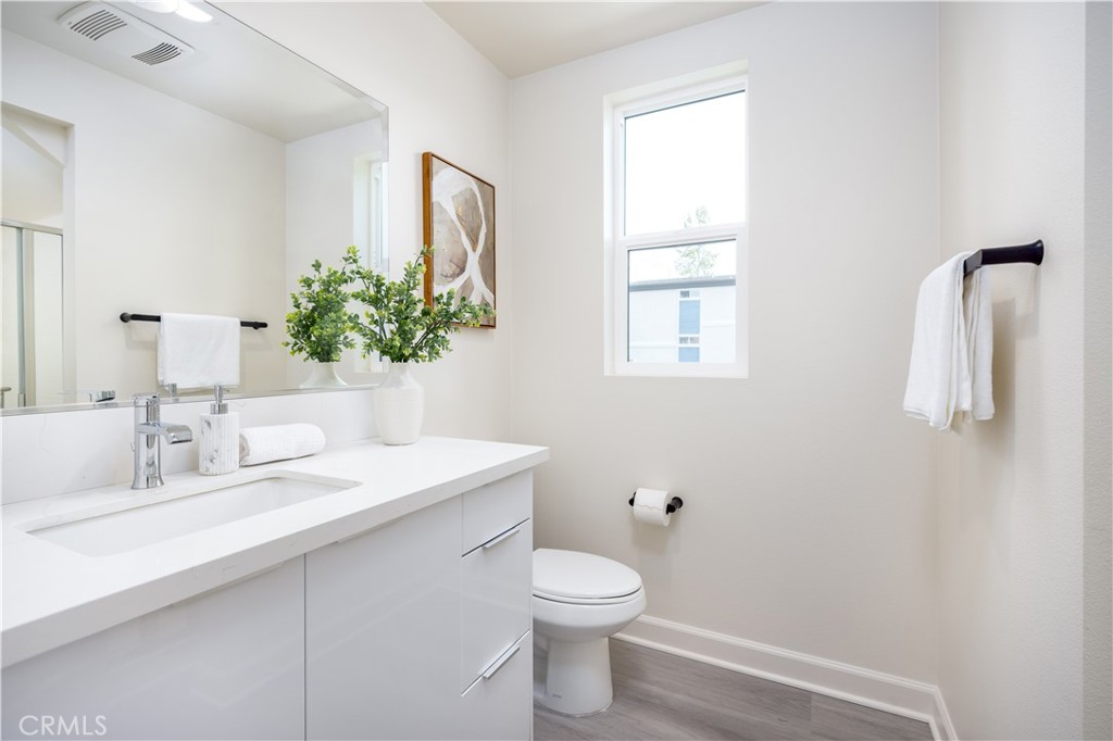 1371 Point Loma Place Walnut, CA 91789 - Photo 26 of 33 a bathroom with a toilet sink and mirror