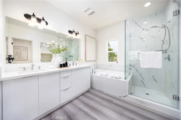 a white toilet sitting next to a bath tub