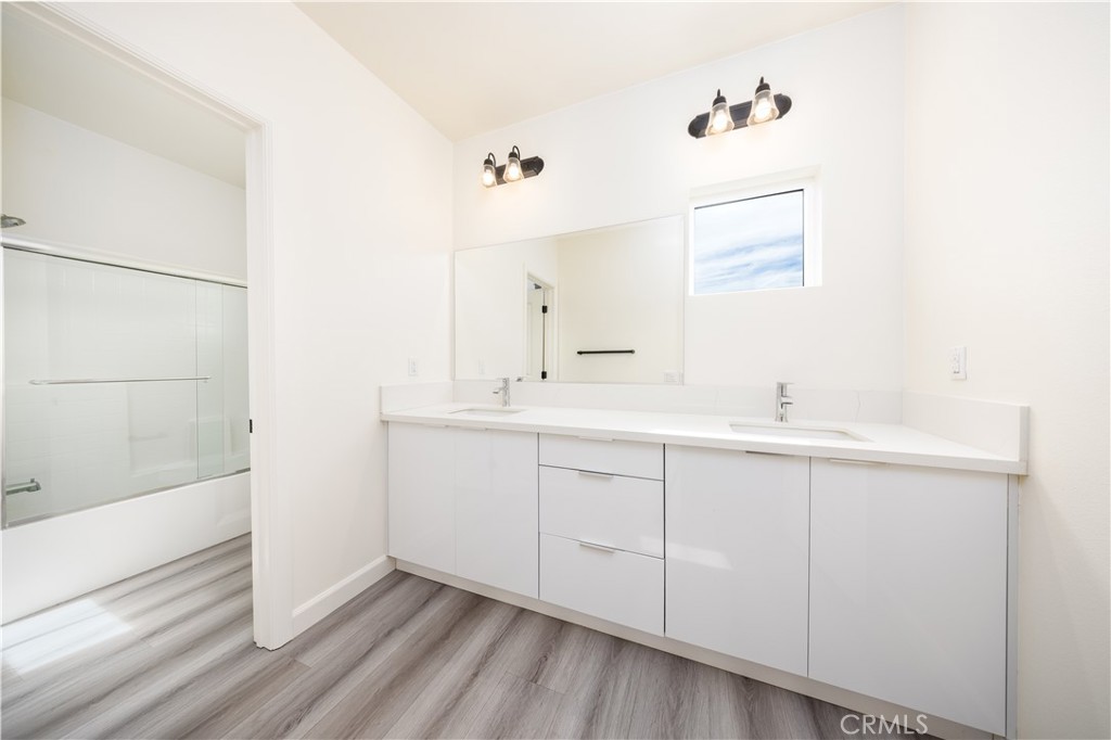 1371 Point Loma Place Walnut, CA 91789 - Photo 30 of 33 a bathroom with a double vanity sink a mirror and a bathtub