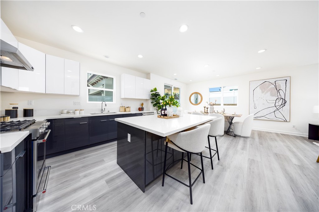 1371 Point Loma Place Walnut, CA 91789 - Photo 4 of 33 a kitchen with stainless steel appliances kitchen island granite countertop a sink a stove a dining table and chairs