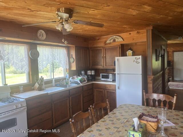 119 South Mountain Road Gilboa, NY 12076 - Photo 12 of 24 a kitchen with a refrigerator and a stove
