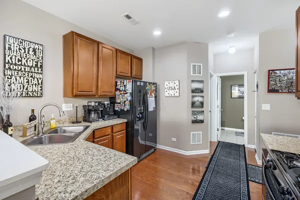a kitchen with stainless steel appliances granite countertop a sink stove and refrigerator