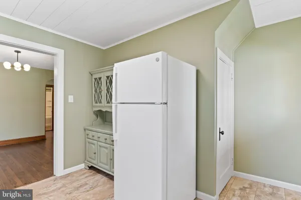 a refrigerator freezer sitting inside of a kitchen