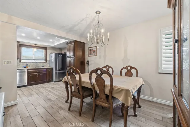a view of a dining room with furniture and a chandelier