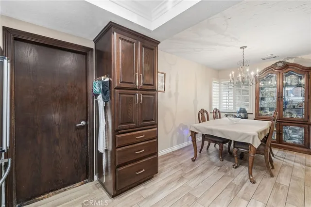 a living room with a flat screen tv and dresser