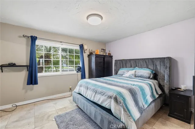 a bathroom with a granite countertop sink a toilet and mirror