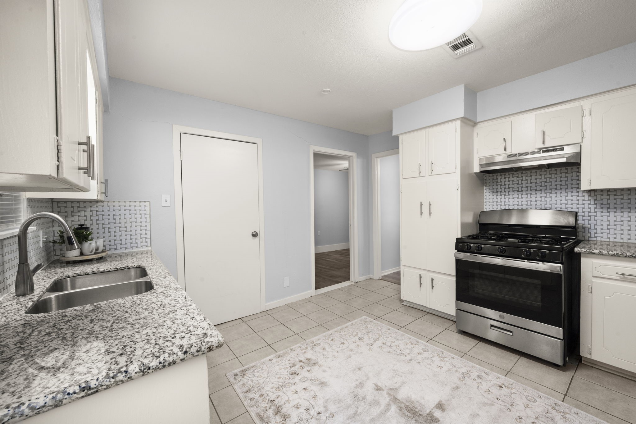 4326 Akard Street Houston, TX 77047 - Photo 18 of 43 a kitchen with stainless steel appliances granite countertop a sink stove and refrigerator