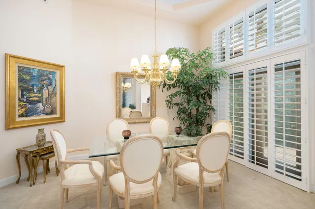 a view of a dining room with furniture and chandelier