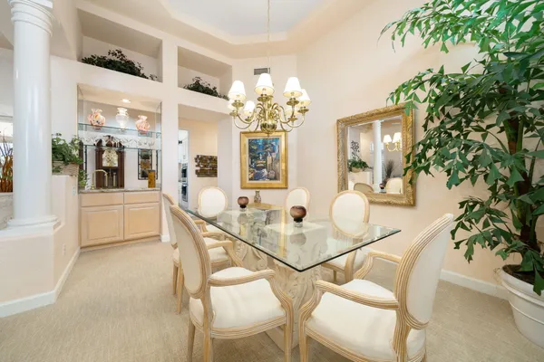 a dining room with furniture and chandelier