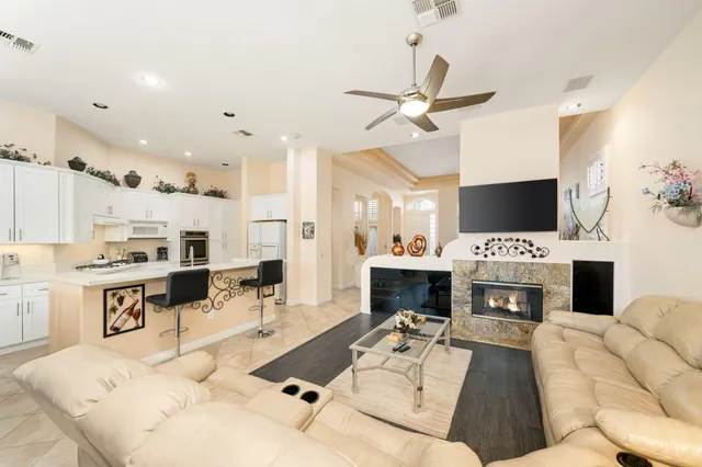 a living room with furniture a fireplace and a flat screen tv