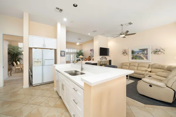 a large white kitchen with a large window