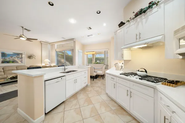 a kitchen with stainless steel appliances a stove a sink and cabinets