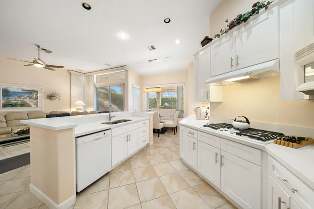 a kitchen with stainless steel appliances a stove a sink and cabinets