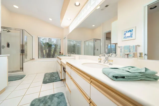 a bathroom with a tub sink and glass door