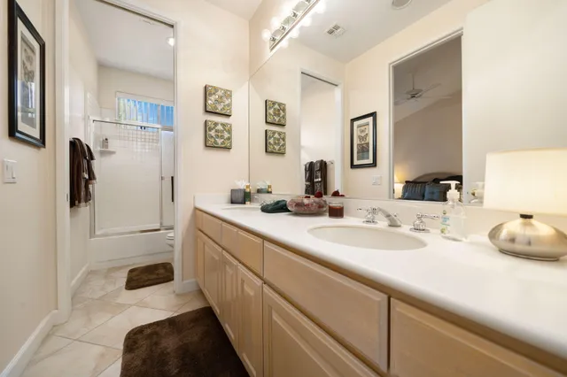a bathroom with a sink double vanity and a mirror