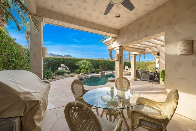 a dining room with furniture a table and chairs