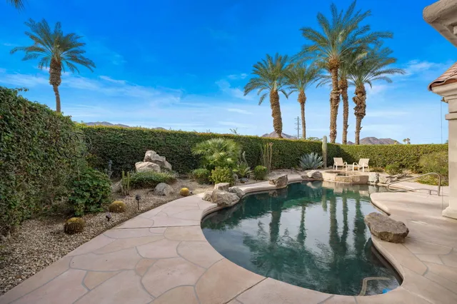 a view of a swimming pool with a table and chairs