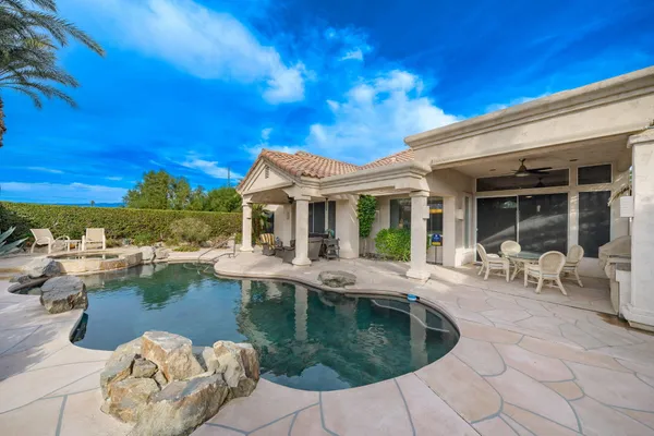 a view of a house with pool table and chairs