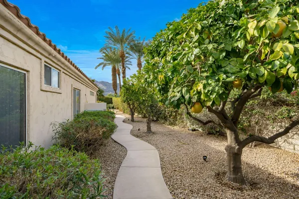 a pathway of a house with a yard